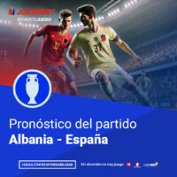 La Imagen Muestra A Jugadores De Los Equipos De Albania Y España En Acción En Un Estadio Iluminado Y Lleno De Espectadores. En La Parte Inferior, Dentro De Un Recuadro Azul, Se Lee El Texto 